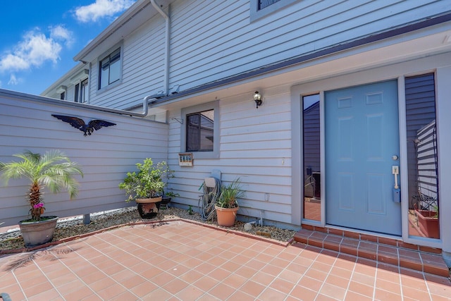 view of exterior entry featuring a patio