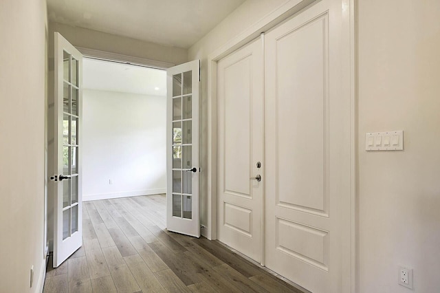 2510 Lake Dr N, Boynton Beach, FL 33435 - corridor featuring french doors, dark wood-style floors, and baseboards