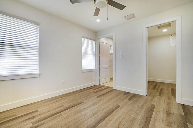 2510 Lake Dr N, Boynton Beach, FL 33435 - unfurnished bedroom featuring light wood-style floors, a spacious closet, baseboards, ceiling fan, and a closet