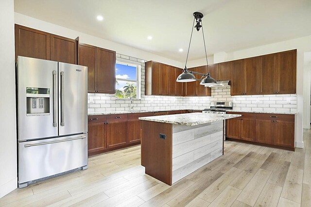 2510 Lake Dr N, Boynton Beach, FL 33435 - kitchen with appliances with stainless steel finishes, light wood-style flooring, extractor fan, backsplash, and recessed lighting