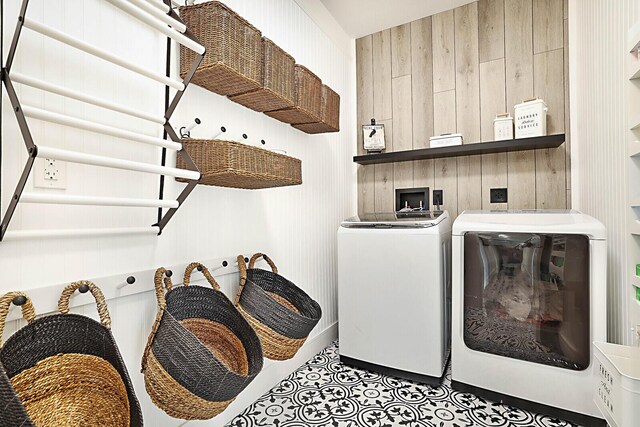 2510 Lake Dr N, Boynton Beach, FL 33435 - laundry area with wood walls, independent washer and dryer, and tile patterned flooring