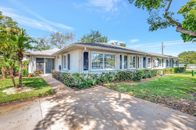 10095 45th Ter S Unit 443, Boynton Beach, FL 33436 - ranch-style house with a front lawn and brick siding