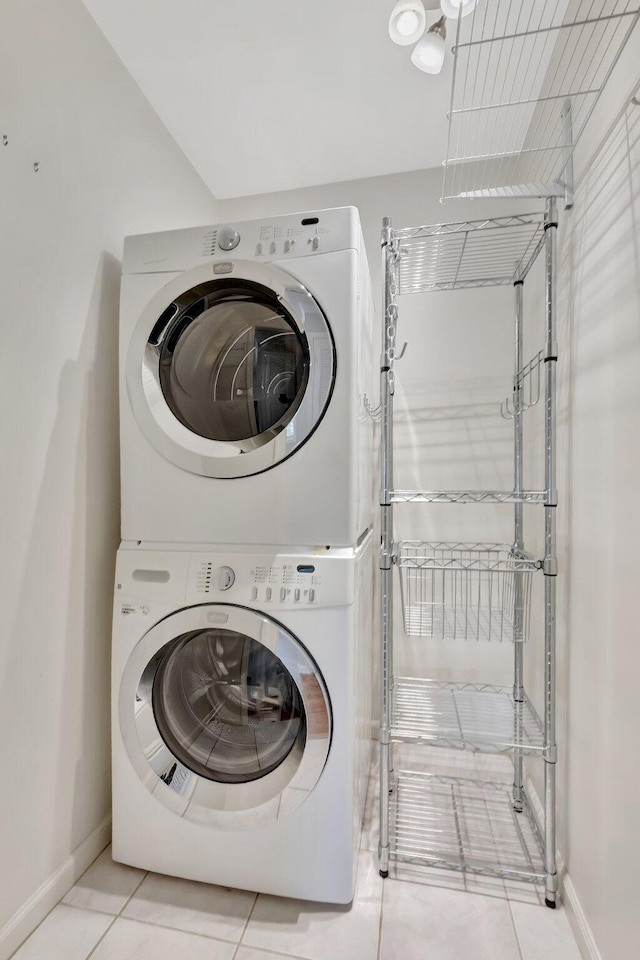 10095 45th Ter S Unit 443, Boynton Beach, FL 33436 - laundry room with estacked washer and dryer, baseboards, and tile patterned flooring