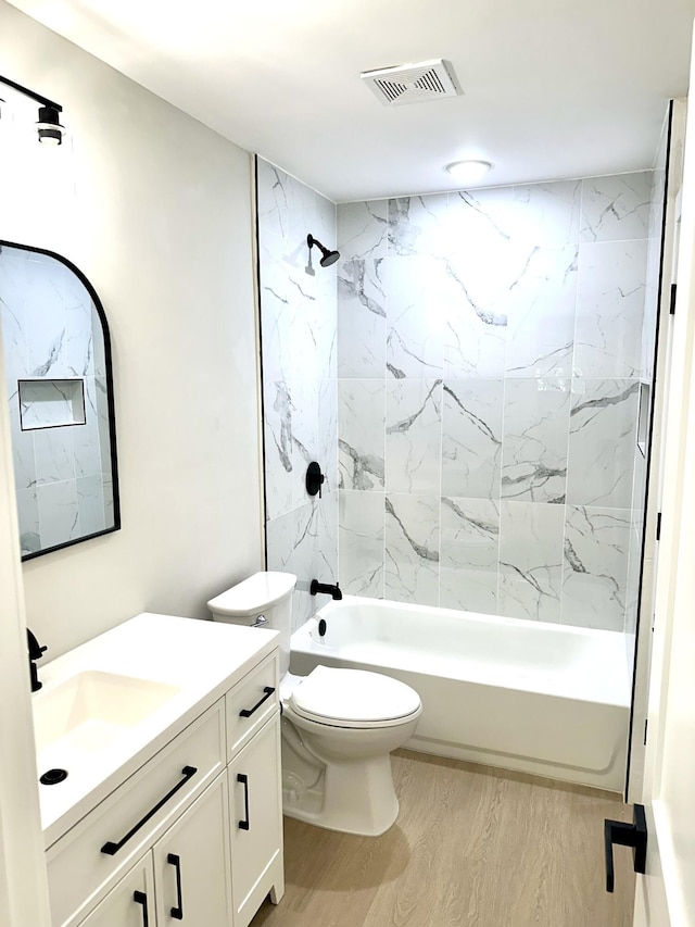 bathroom with shower / washtub combination, vanity, toilet, and wood finished floors