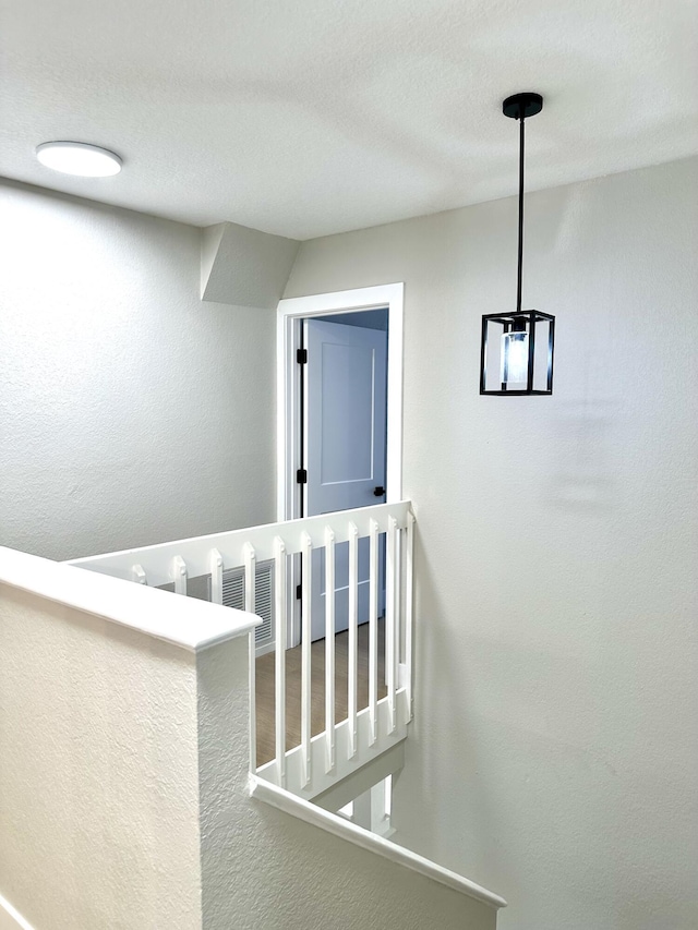 staircase with a textured wall
