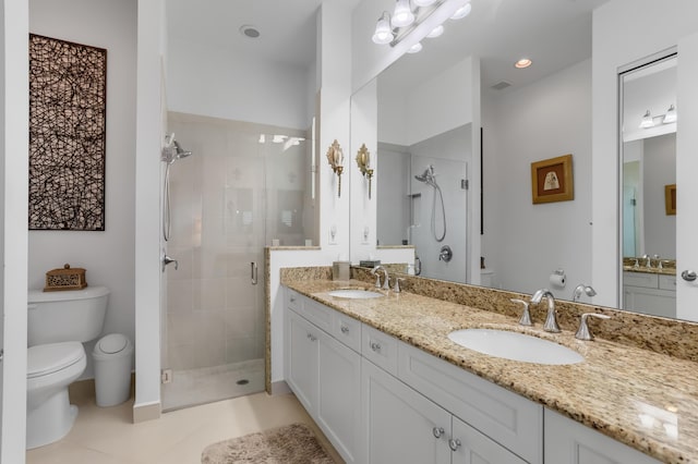 7779 Butera Plz, Delray Beach, FL 33446 - bathroom featuring toilet, a stall shower, double vanity, tile patterned floors, and baseboards