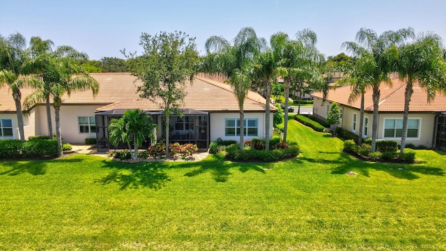 7779 Butera Plz, Delray Beach, FL 33446 - back of house with a tiled roof, stucco siding, a yard, and glass enclosure