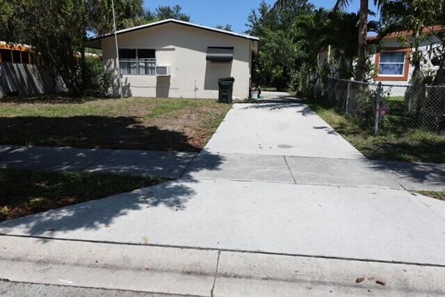 1454 NE 2nd Ct, Boca Raton, FL 33432 - view of front of property featuring concrete driveway and fence