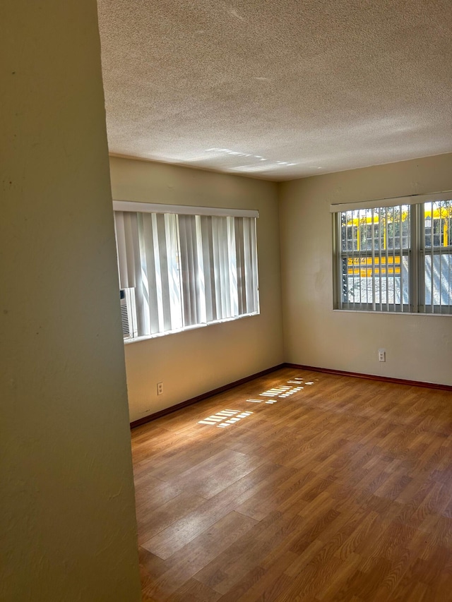 1454 NE 2nd Ct, Boca Raton, FL 33432 - spare room with a textured ceiling, wood finished floors, and baseboards