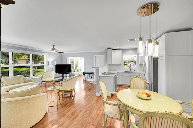 4585 NW 3rd St Unit D, Delray Beach, FL 33445 - dining space with light wood-type flooring, ceiling fan, crown molding, recessed lighting, and baseboards