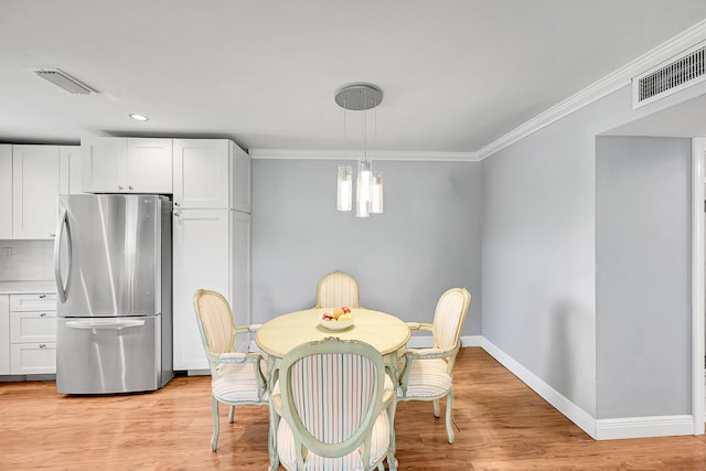 4585 NW 3rd St Unit D, Delray Beach, FL 33445 - dining space with baseboards, crown molding, recessed lighting, and light wood finished floors