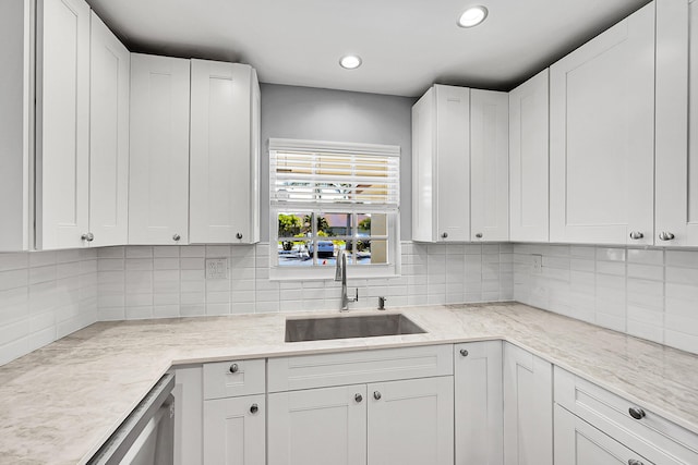 4585 NW 3rd St Unit D, Delray Beach, FL 33445 - kitchen featuring a sink, white cabinetry, recessed lighting, and decorative backsplash
