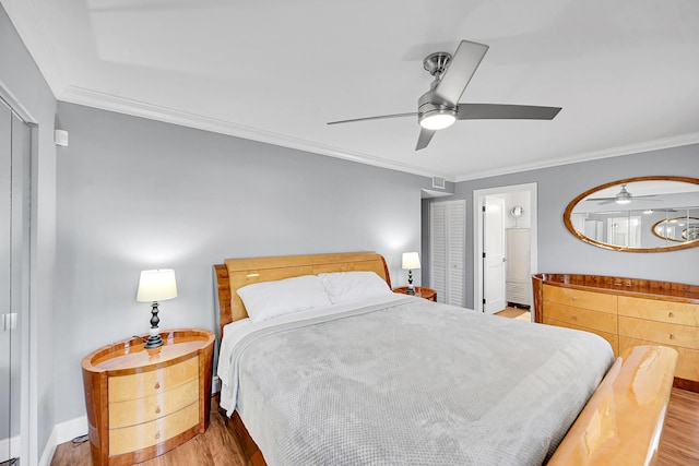 4585 NW 3rd St Unit D, Delray Beach, FL 33445 - bedroom featuring wood finished floors, ornamental molding, baseboards, a ceiling fan, and ensuite bath