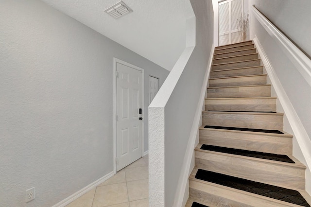 2556 Marshfield Ct, Port Saint Lucie, FL 34953 - staircase with tile patterned floors and baseboards