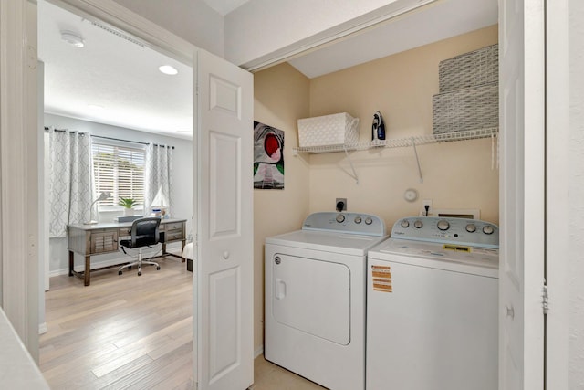 2556 Marshfield Ct, Port Saint Lucie, FL 34953 - washroom with washing machine and clothes dryer, light wood-type flooring, a desk, and baseboards