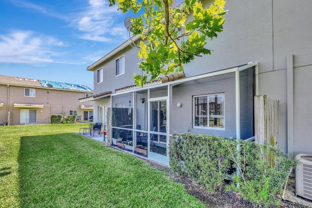 2556 Marshfield Ct, Port Saint Lucie, FL 34953 - back of house with a lawn, cooling unit, a sunroom, and stucco siding
