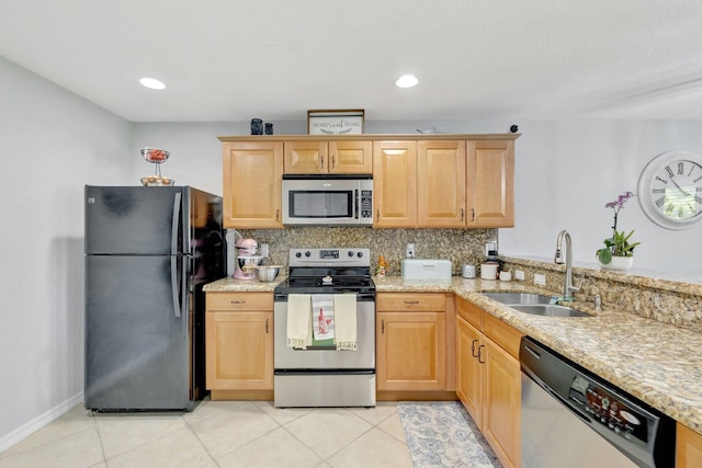 2556 Marshfield Ct, Port Saint Lucie, FL 34953 - kitchen featuring appliances with stainless steel finishes, a sink, decorative backsplash, light stone counters, and light tile patterned floors