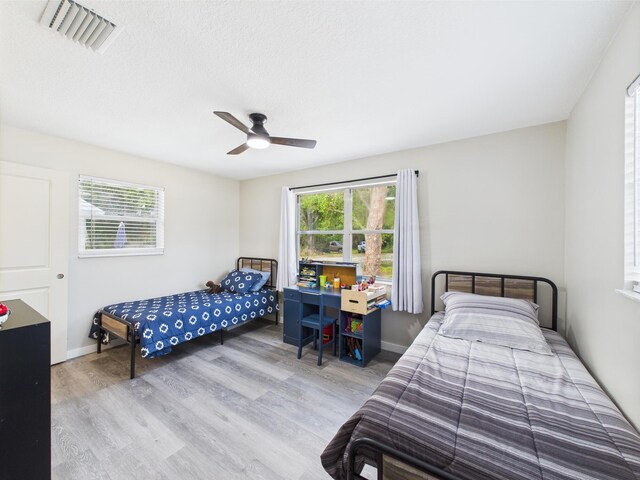 bedroom featuring wood finished floors, ceiling fan, and baseboards