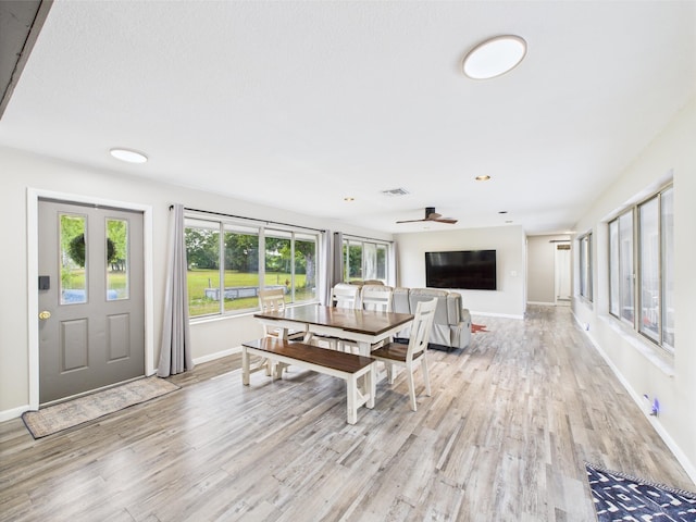 living room featuring light wood-style flooring, baseboards, and recessed lighting