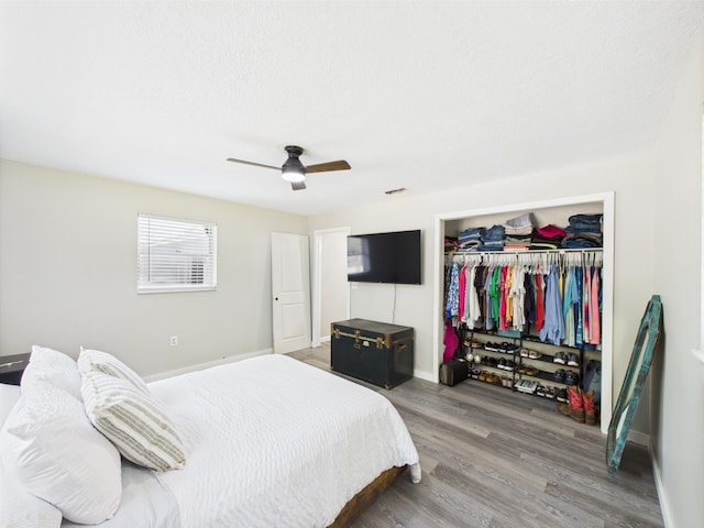 bedroom featuring a closet, wood finished floors, and baseboards