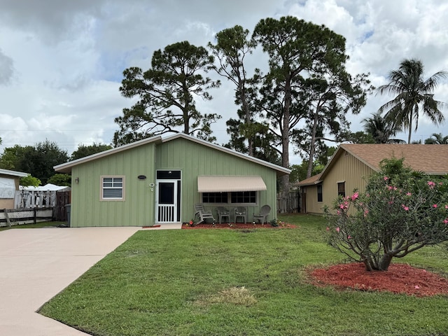 5123 Adams Rd, Delray Beach, FL 33484 - view of front of house with driveway and board and batten siding