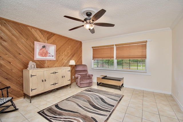 5123 Adams Rd, Delray Beach, FL 33484 - living area featuring light tile patterned floors, wood walls, ceiling fan, crown molding, and baseboards