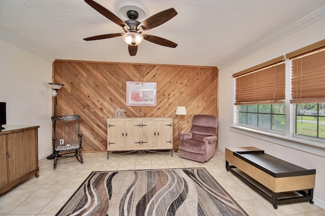 5123 Adams Rd, Delray Beach, FL 33484 - sitting room with wooden walls, light tile patterned floors, ornamental molding, ceiling fan, and a textured ceiling