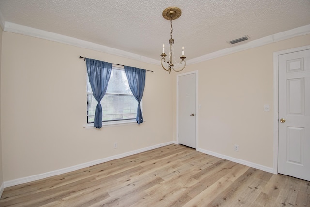 5123 Adams Rd, Delray Beach, FL 33484 - empty room with a textured ceiling, light wood-style flooring, a chandelier, baseboards, and crown molding