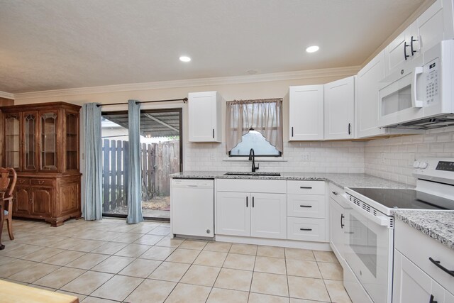 5123 Adams Rd, Delray Beach, FL 33484 - kitchen with white appliances, a sink, ornamental molding, tasteful backsplash, and light tile patterned floors