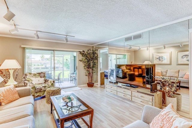 1160 Sugar Sands Blvd Fl 403-1St, Singer Island, FL 33404 - living area featuring track lighting, wood finished floors, crown molding, a textured ceiling, and baseboards