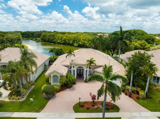21675 Fall River Dr, Boca Raton, FL 33428 - view of front facade with decorative driveway, a water view, a tile roof, french doors, and stucco siding