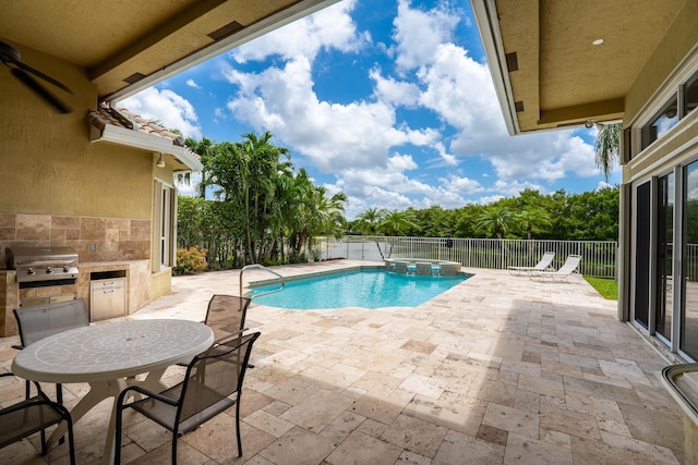 21675 Fall River Dr, Boca Raton, FL 33428 - view of pool with a patio, a fenced backyard, a pool with connected hot tub, and exterior kitchen
