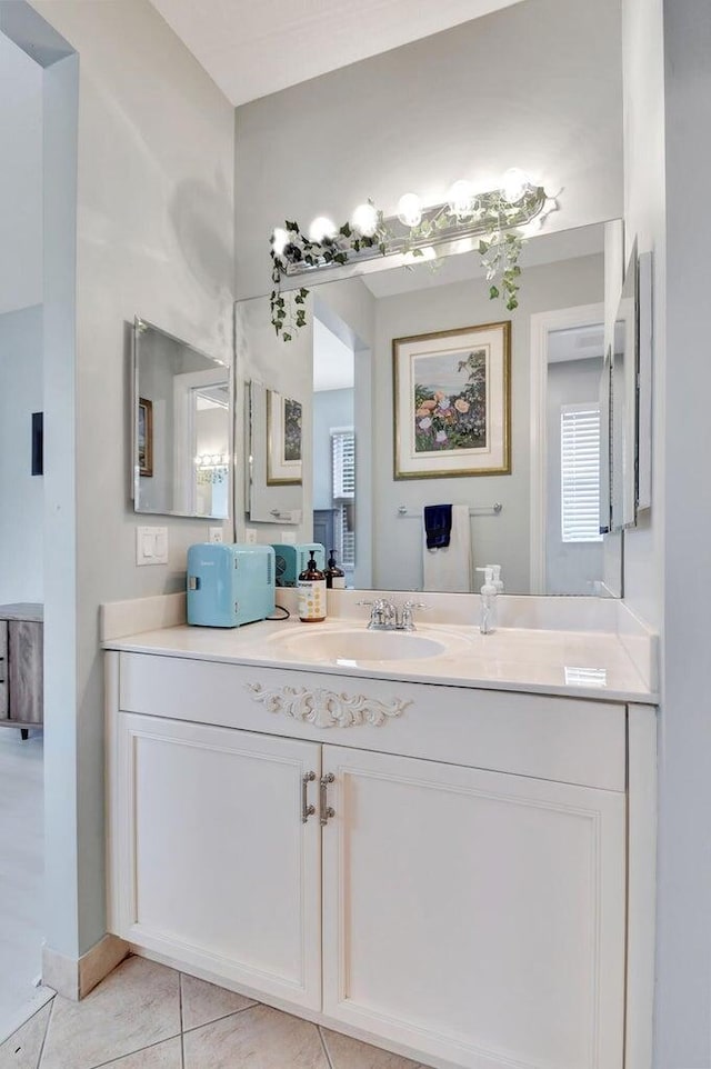 bathroom with tile patterned flooring, vanity, and plenty of natural light