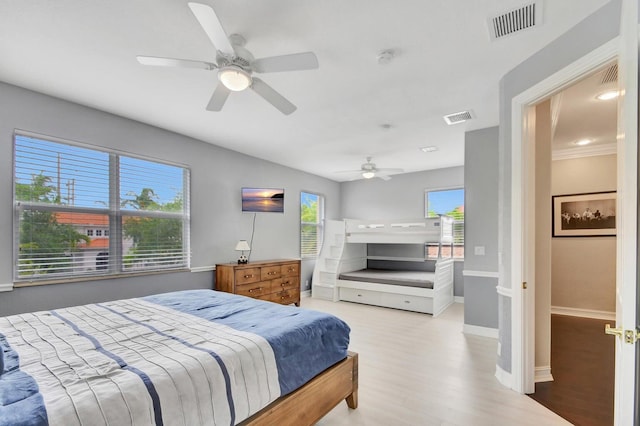 bedroom featuring wood finished floors, a ceiling fan, and baseboards