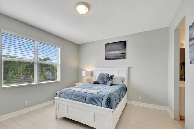 bedroom with baseboards and light wood-type flooring