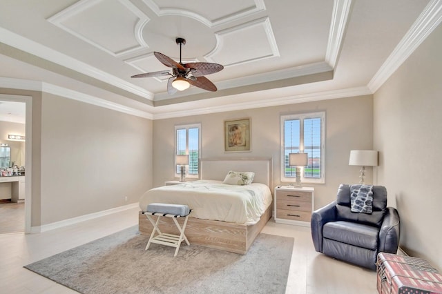 bedroom featuring multiple windows, a tray ceiling, light wood-style floors, and ornamental molding