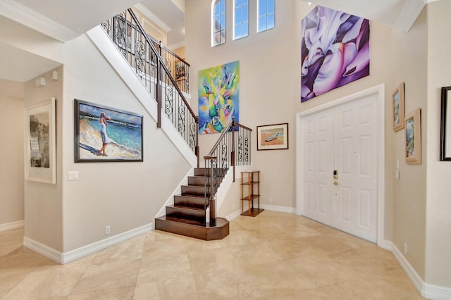 entryway featuring a high ceiling, stairway, and baseboards