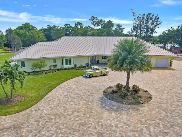 6624 Dillman Rd, West Palm Beach, FL 33413 - single story home featuring curved driveway, metal roof, stucco siding, and a front lawn