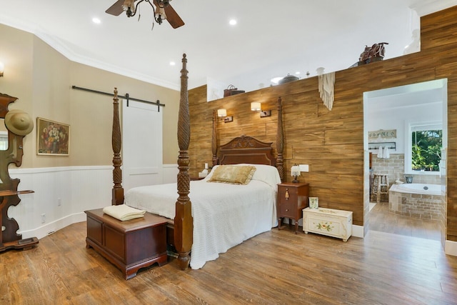 6624 Dillman Rd, West Palm Beach, FL 33413 - bedroom with a barn door, wood finished floors, ornamental molding, a wainscoted wall, and recessed lighting