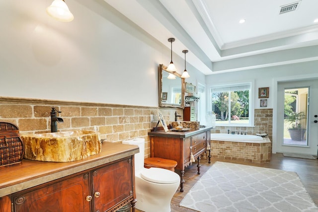 6624 Dillman Rd, West Palm Beach, FL 33413 - full bath featuring vanity, a garden tub, wood finished floors, toilet, and tile walls