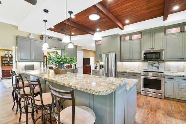 6624 Dillman Rd, West Palm Beach, FL 33413 - kitchen with stainless steel appliances, wood ceiling, beamed ceiling, tasteful backsplash, and light wood-type flooring