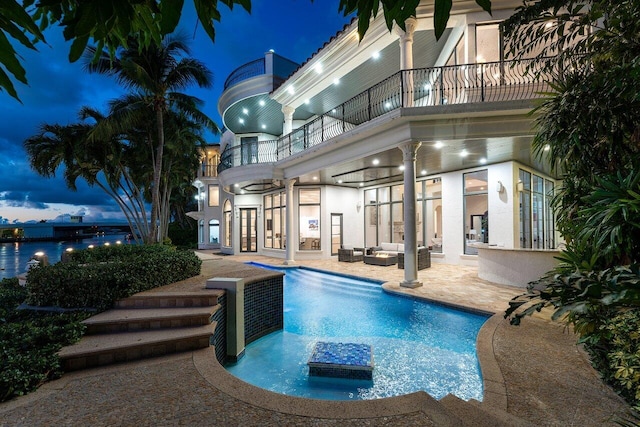 155 SE Spanish Trl, Boca Raton, FL 33432 - pool at night with a patio, an outdoor hangout area, an outdoor pool, and french doors