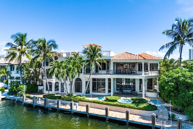 155 SE Spanish Trl, Boca Raton, FL 33432 - rear view of property with a balcony, a patio, a water view, a tiled roof, and stucco siding