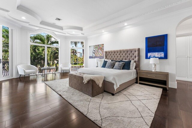 155 SE Spanish Trl, Boca Raton, FL 33432 - bedroom featuring hardwood / wood-style floors, ornamental molding, multiple windows, a raised ceiling, and arched walkways