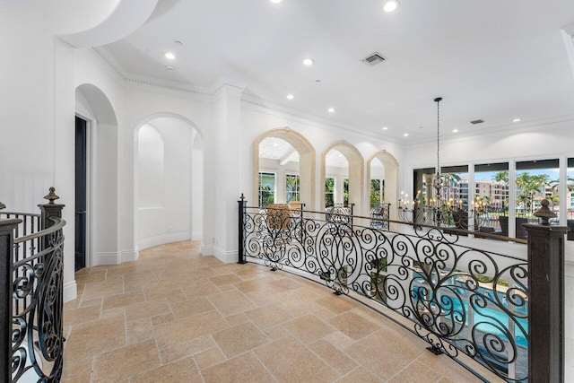 155 SE Spanish Trl, Boca Raton, FL 33432 - hall featuring ornamental molding, healthy amount of natural light, stone tile flooring, recessed lighting, and an upstairs landing