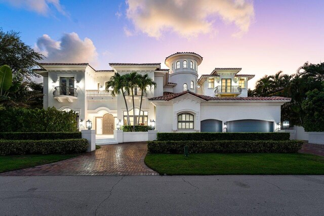 155 SE Spanish Trl, Boca Raton, FL 33432 - mediterranean / spanish-style home with a balcony, stucco siding, decorative driveway, and a tiled roof