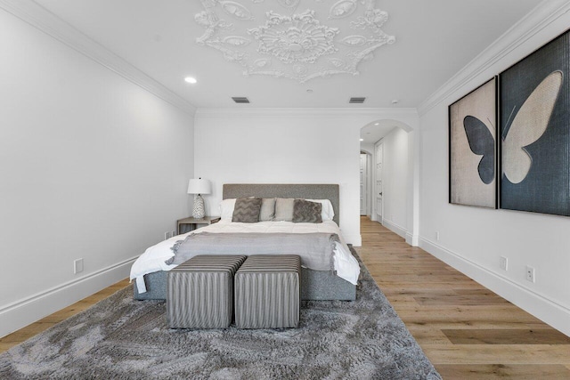 155 SE Spanish Trl, Boca Raton, FL 33432 - bedroom with arched walkways, crown molding, recessed lighting, baseboards, and wood finished floors