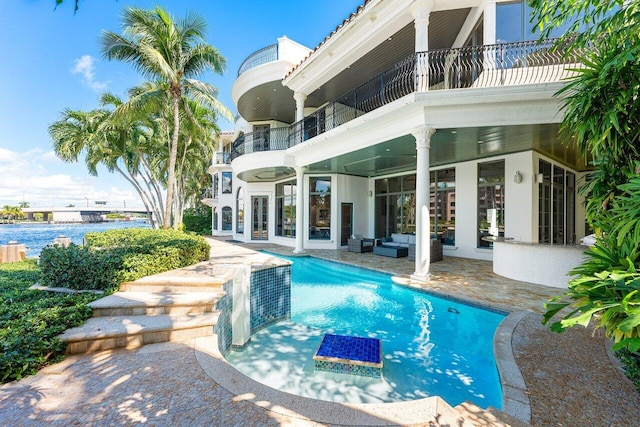 155 SE Spanish Trl, Boca Raton, FL 33432 - swimming pool with an outdoor living space, a patio, and french doors