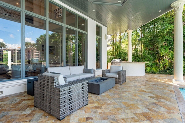 155 SE Spanish Trl, Boca Raton, FL 33432 - view of patio with an outdoor living space with a fire pit