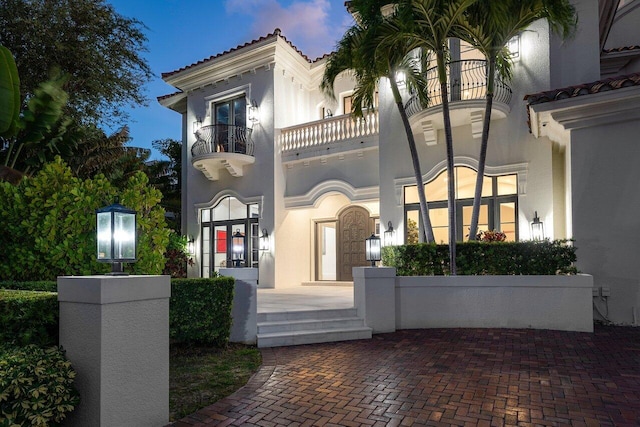 155 SE Spanish Trl, Boca Raton, FL 33432 - mediterranean / spanish house featuring a balcony, stucco siding, and a tiled roof